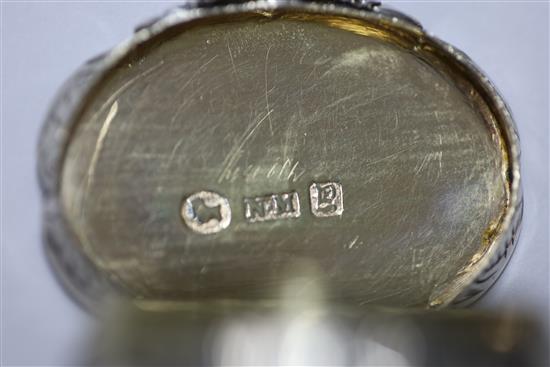 A Victorian silver cusped oval vinaigrette by Nathaniel Mills, the lid engraved with houses,